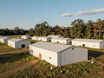 Modern poultry barns on an Alabama farm surrounded by green grass in the Tennessee Valley