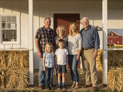 Multi-generational farm family on a farmhouse porch - family values in Christian farming life